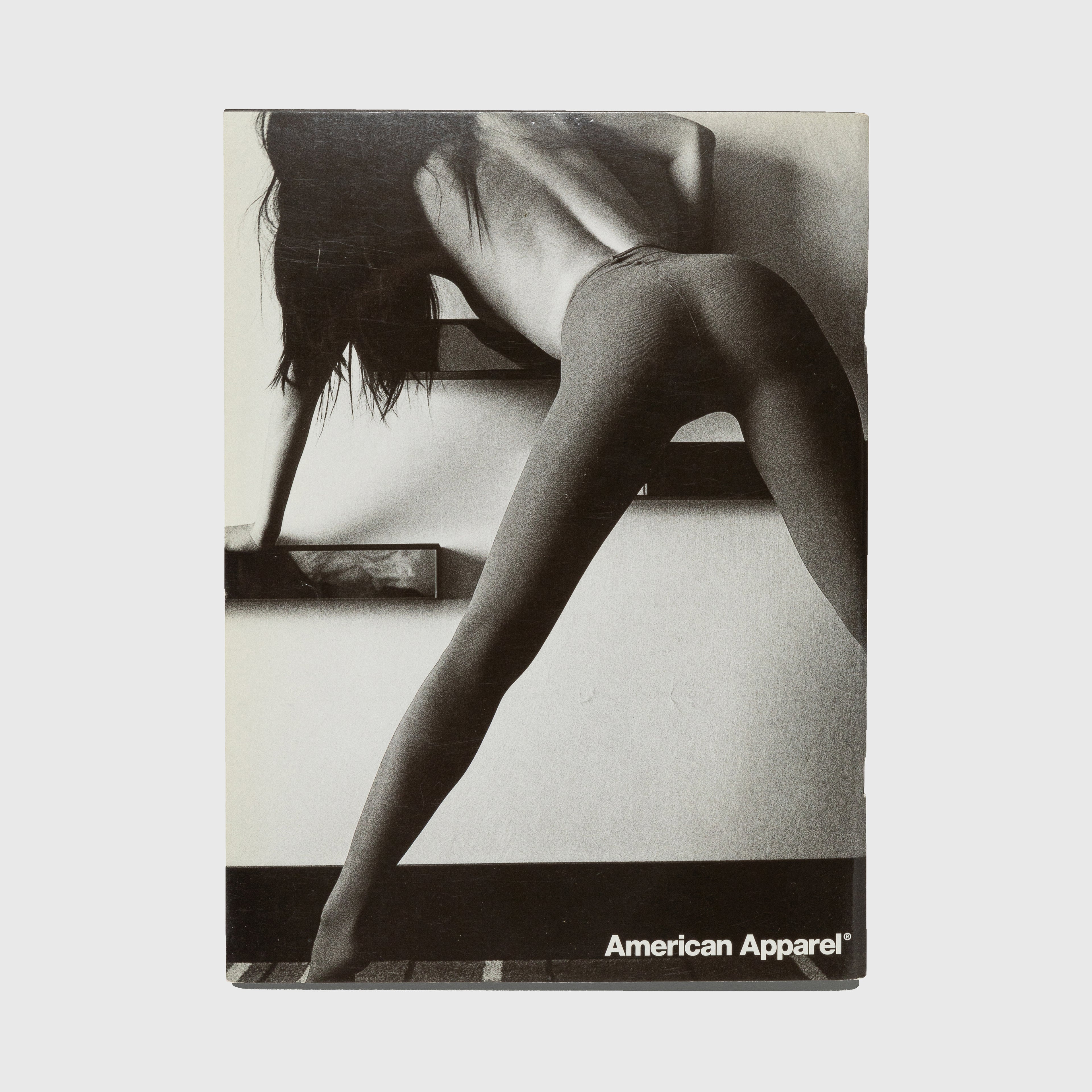 Black and white advertisement for American Apparel featuring a person wearing tights. Dash Snow for Purple magazine.