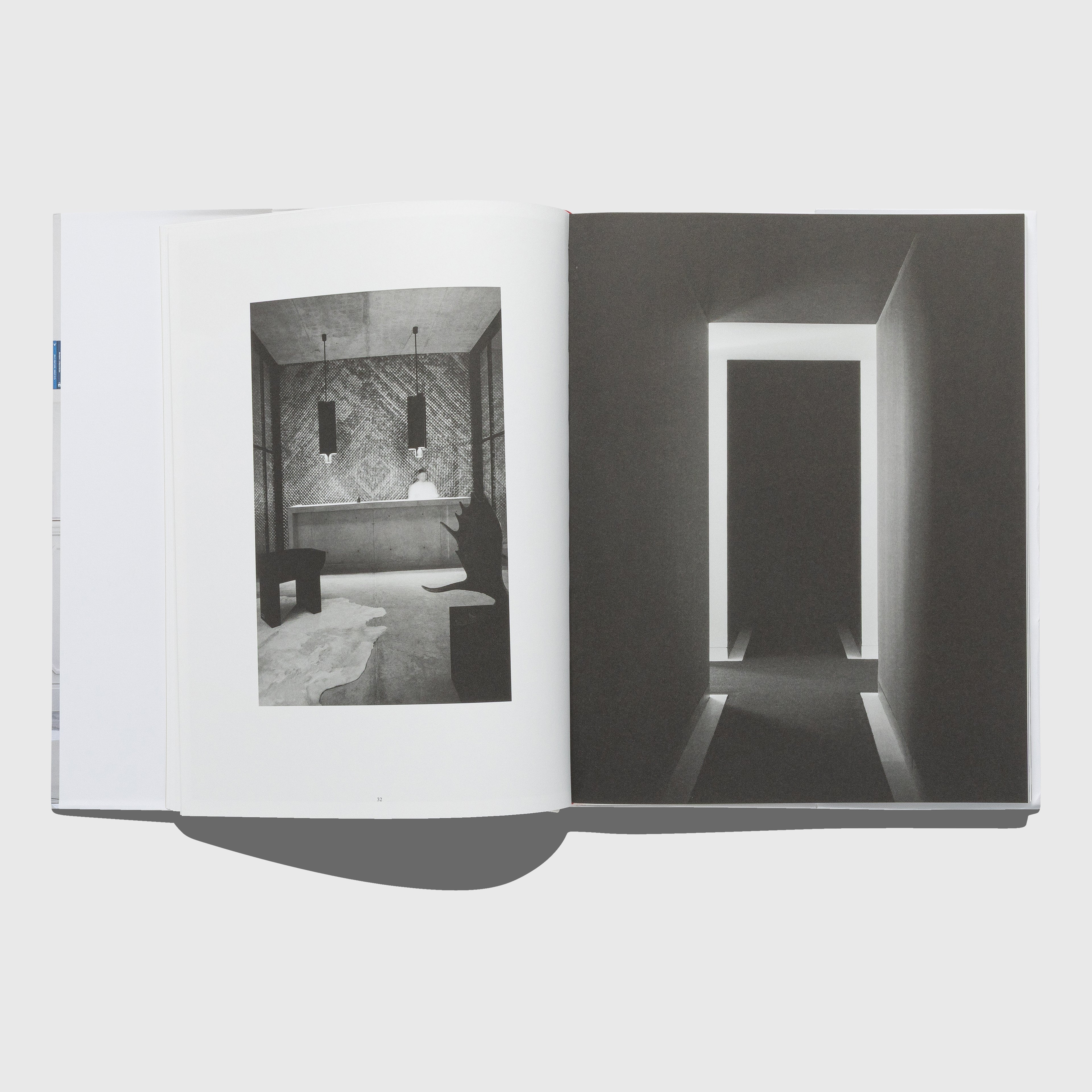Open book showing black and white interior design images on a white background. Rick Owens furniture. Interior by Joseph Dirand. Published by Rizzoli.