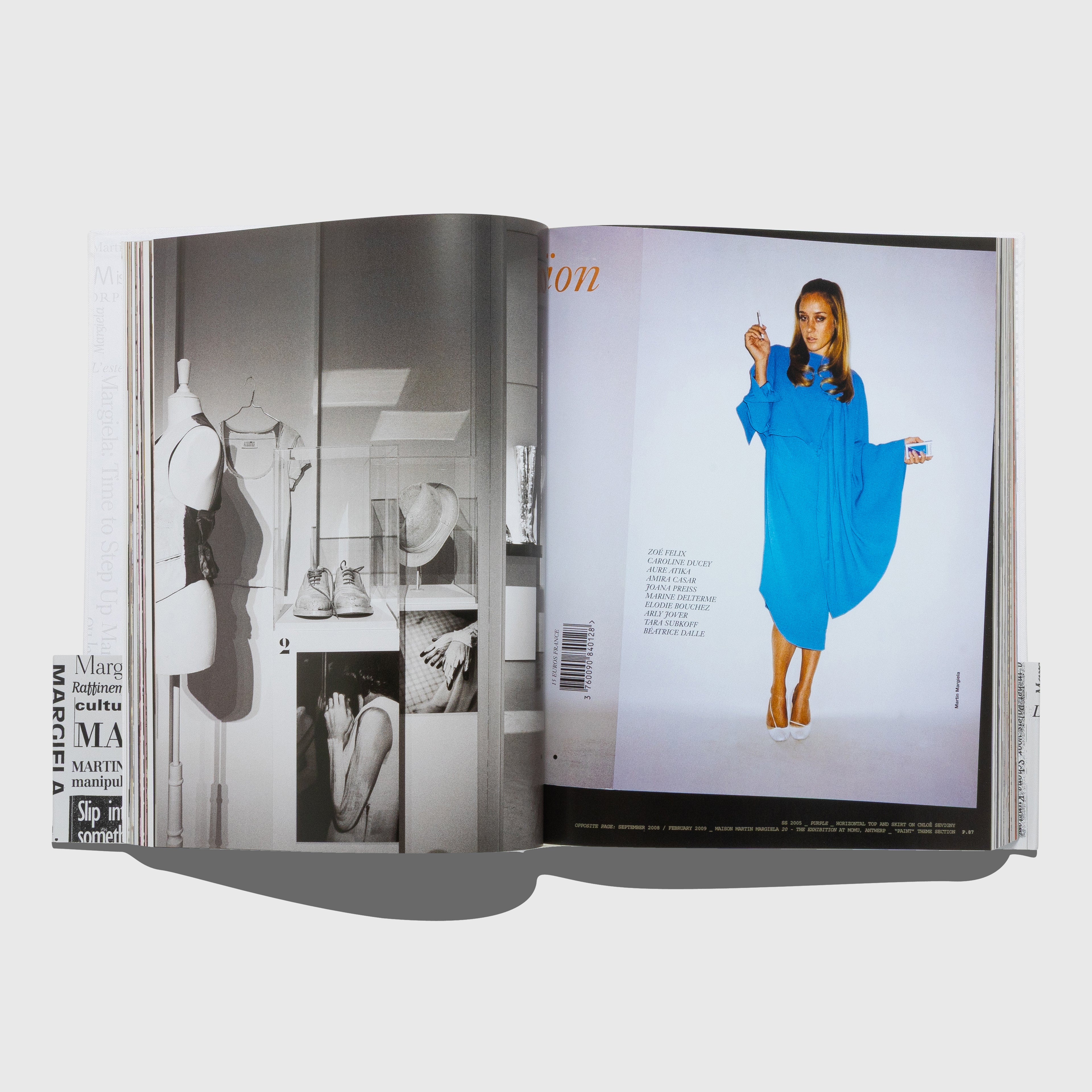 Open book showing a Purple fashion magazine editorial with Chloë Sevigny in a blue dress. Maison Martin Margiela book published by Rizzoli.