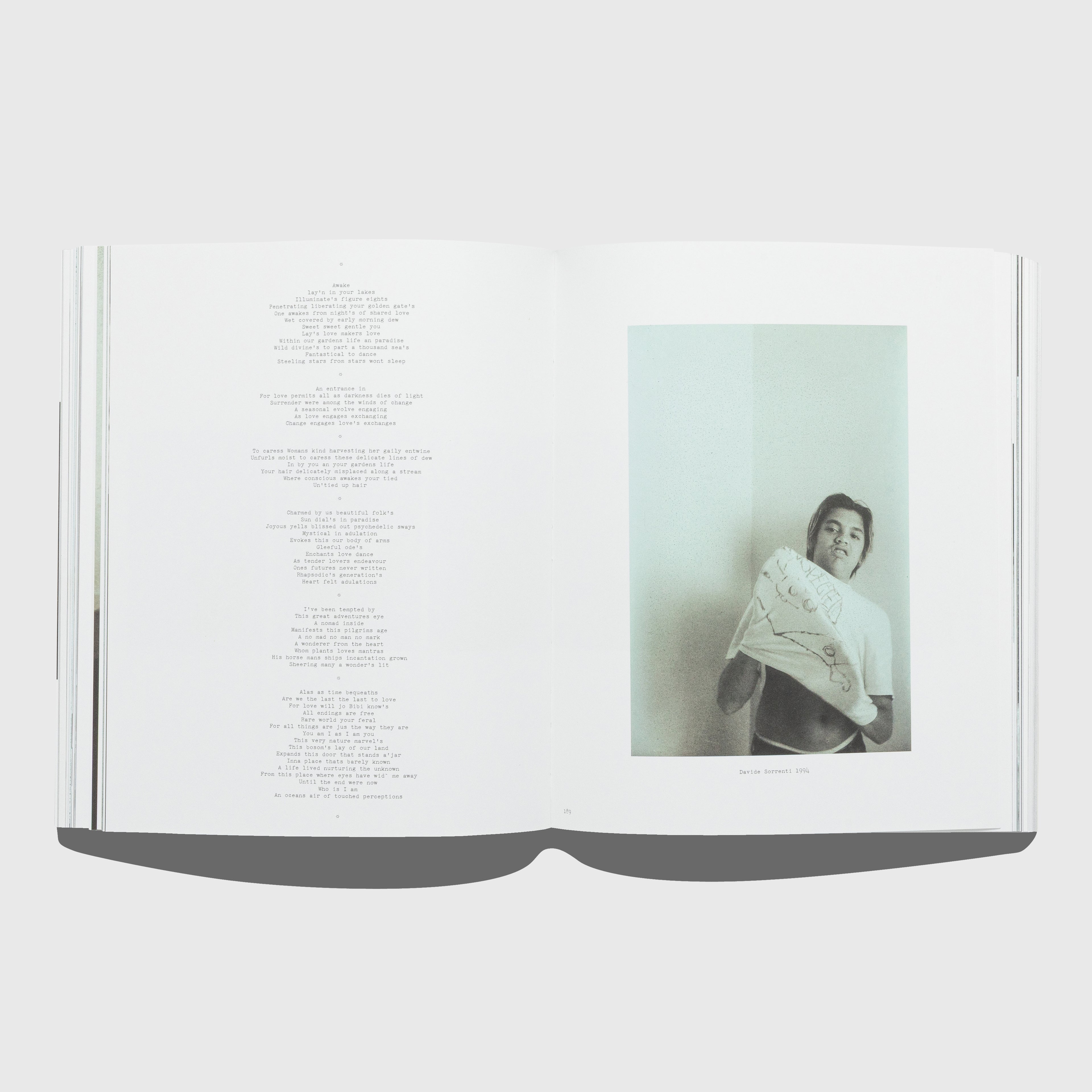 Open book with a photograph of Davide Sorrenti wrapped in a blanket on a white background. Out of Date book by Mark Borthwick. Published by Rizzoli.