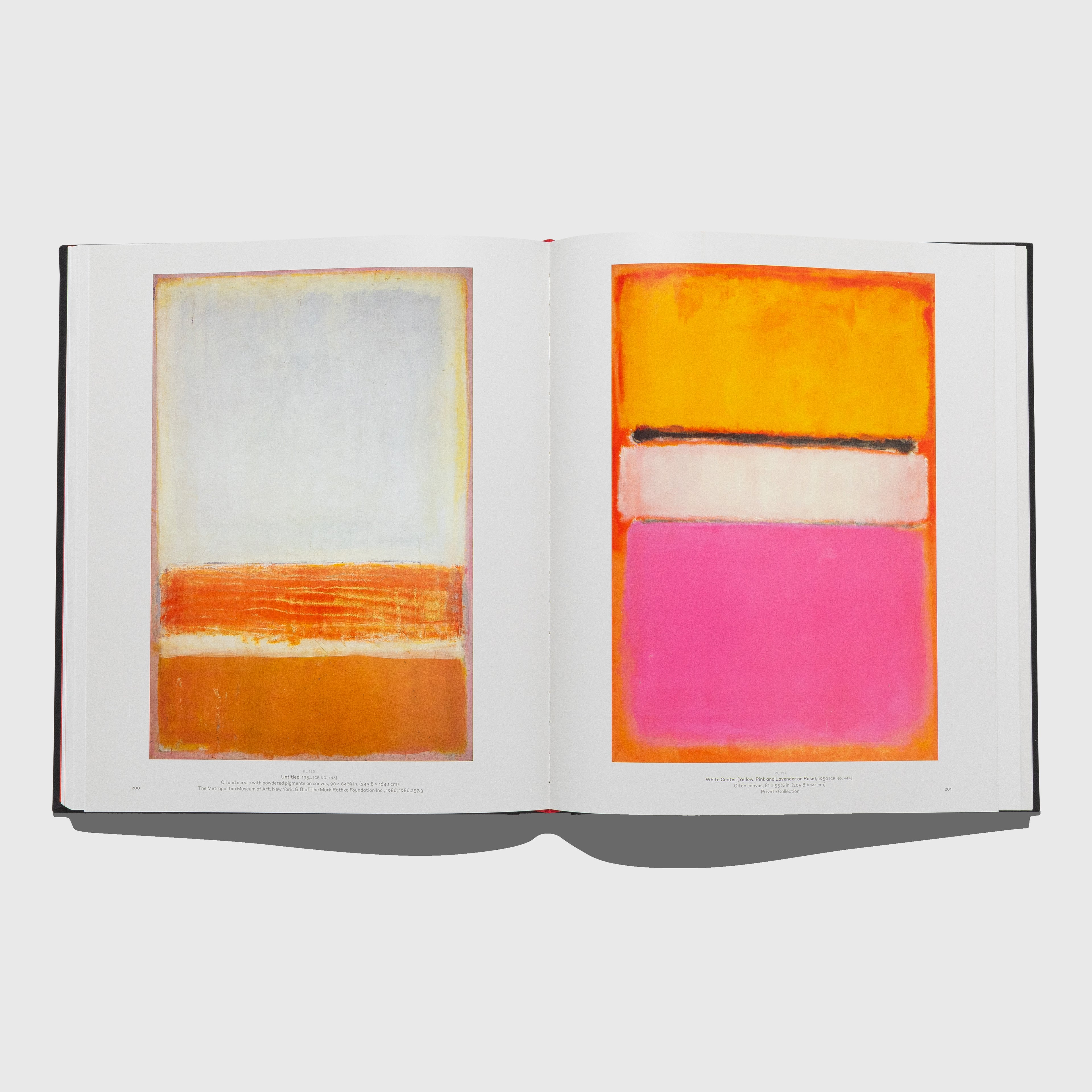 Open book displaying abstract art with orange, pink, and white rectangles on a white background. Mark Rothko art book published by Rizzoli Electa.