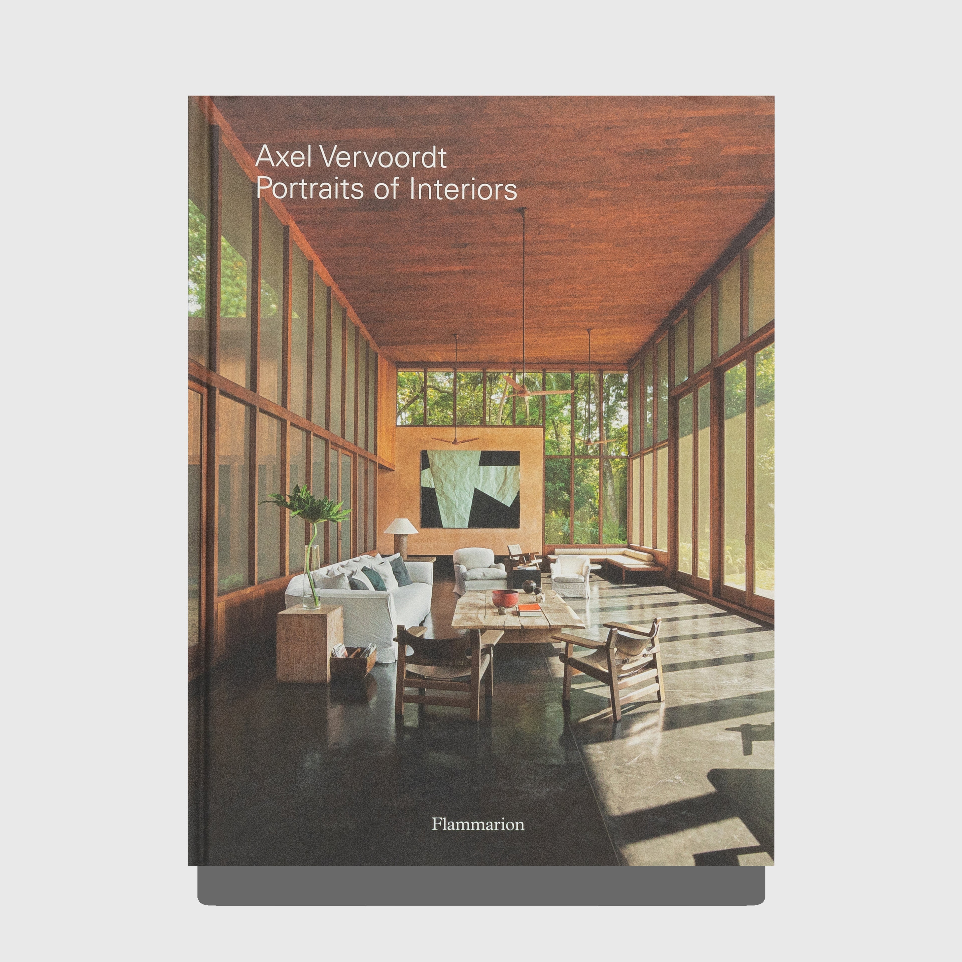 Book cover of 'Portraits of Interiors' by Axel Vervoordt with a modern interior design on the cover. Published by Flammarion.