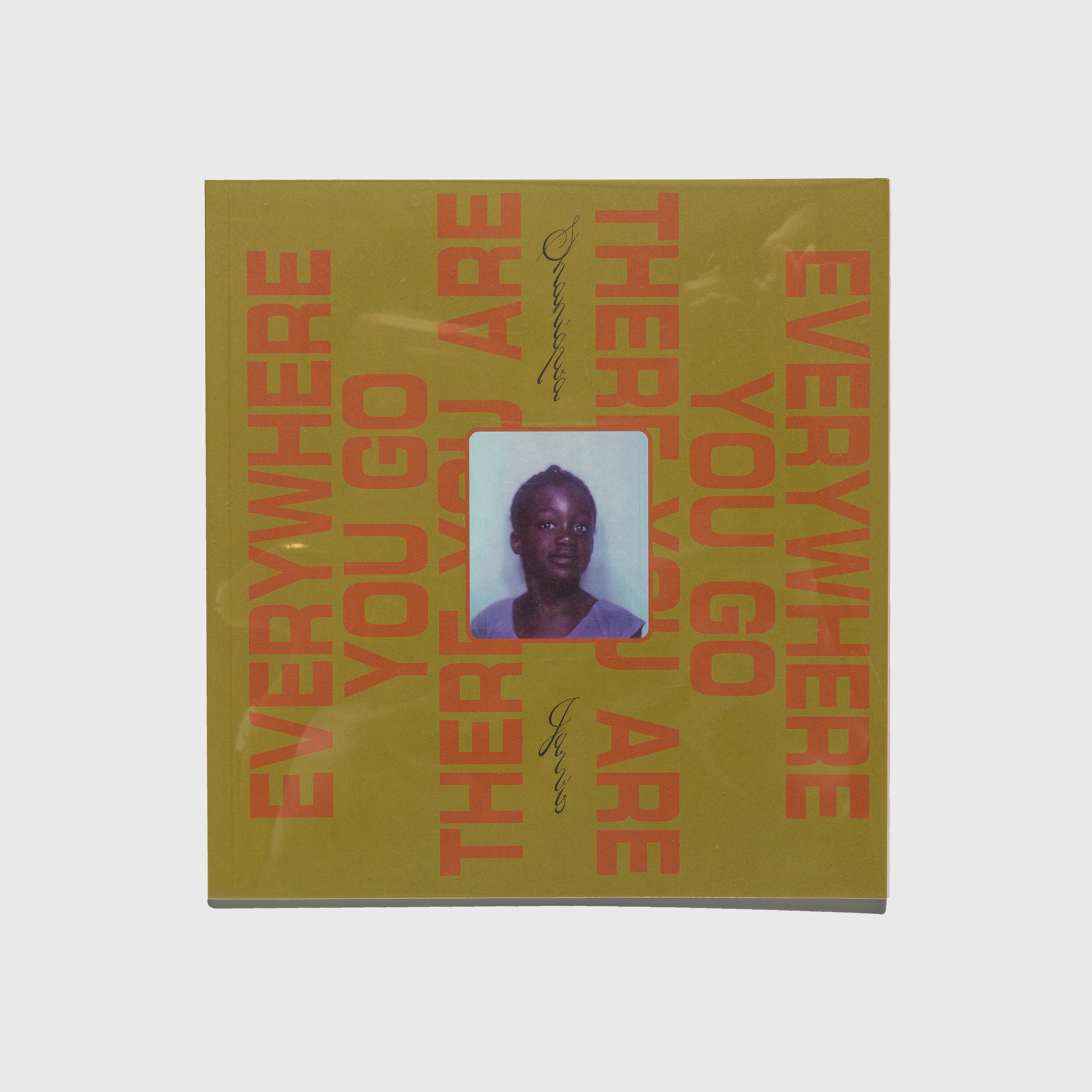 Book cover with text 'Everywhere You Go' and a small portrait on a yellow background. Shaniqwa Jarvis.