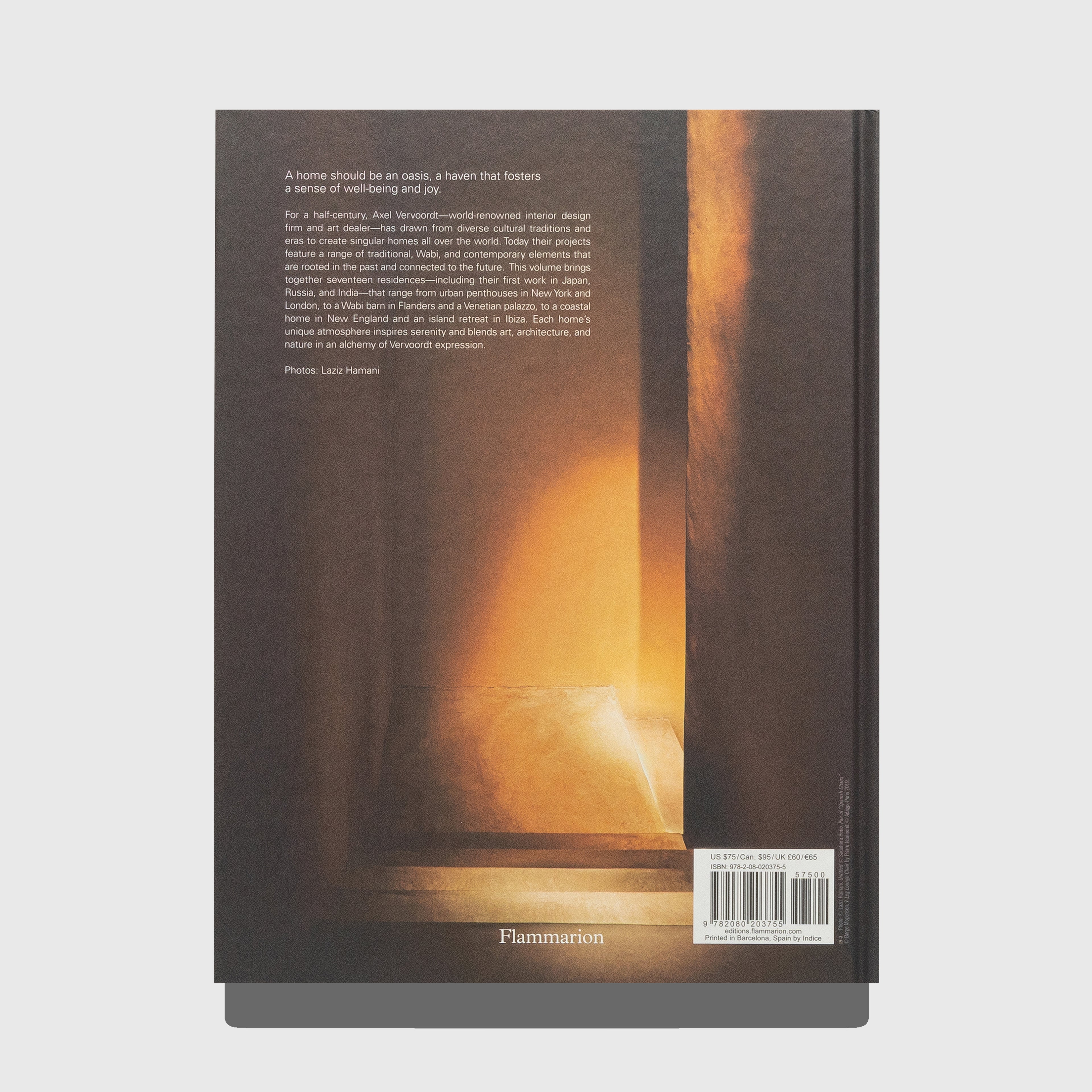 Book cover with warm interior scene. Portraits of Interiors by Axel Vervoordt published by Flammarion.