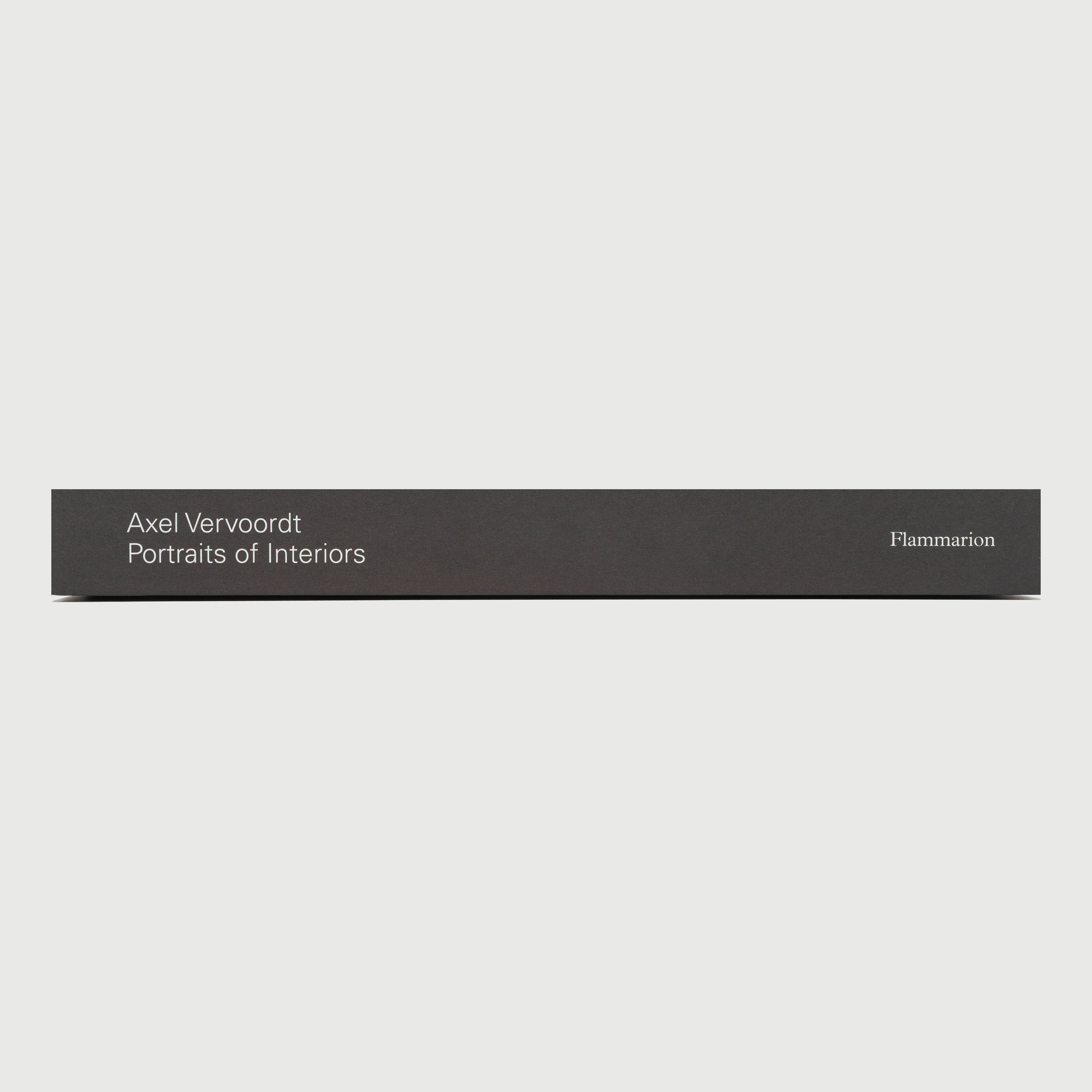 Book cover with text 'Axel Vervoordt Portraits of Interiors' by Flammarion on a gray background