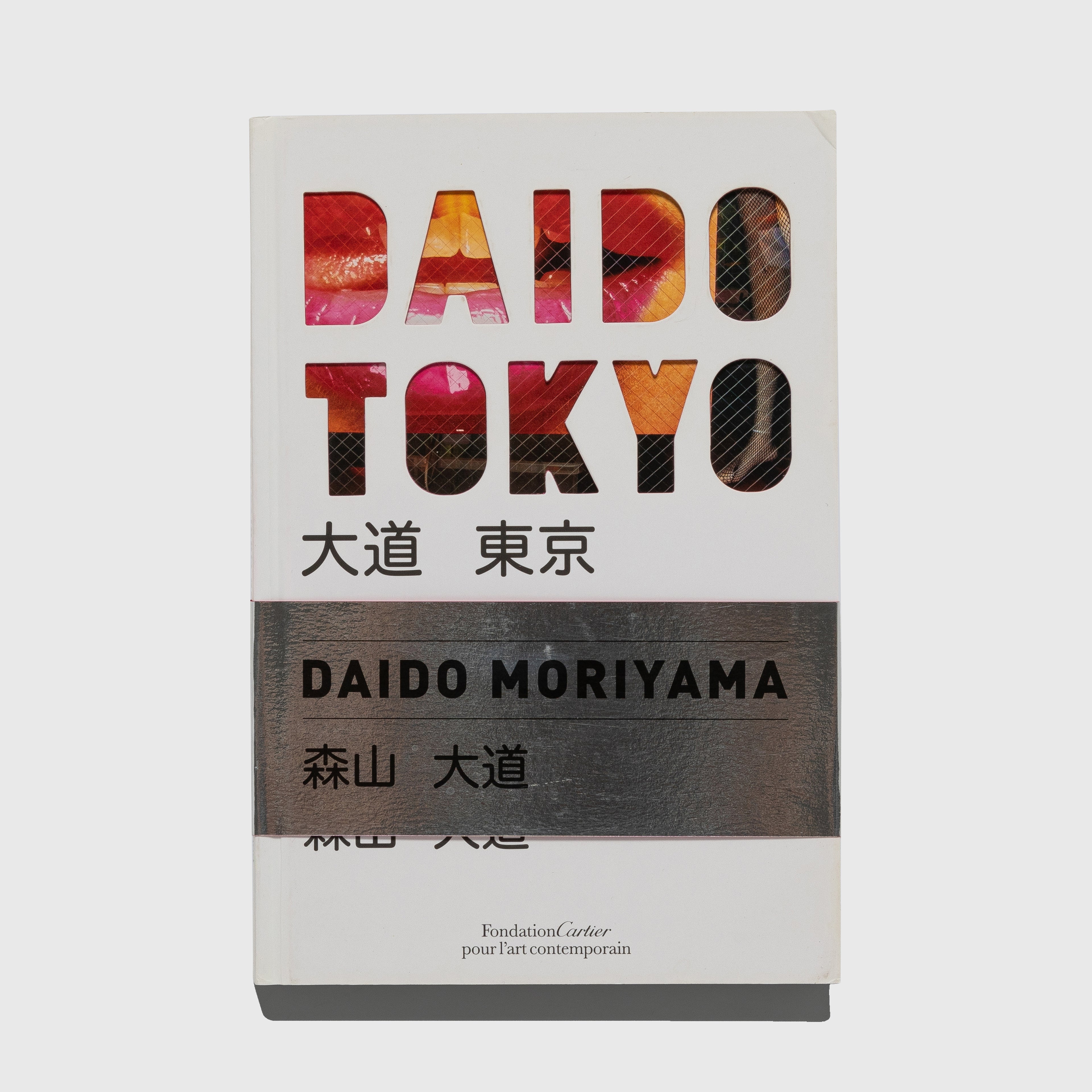 Book cover of 'DAIDO TOKYO' by Daido Moriyama with colorful text design on a grey background.